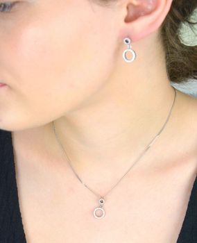Stylowa srebrna zawieszka próby 925 z dwoma połączonymi kółeczkami, ozdobiona lśniącymi cyrkoniami. Symboliczna forma i elegancki blask – idealna na prezent lub do codziennych stylizacji. delikatny blask  W 2231  (1).JPG